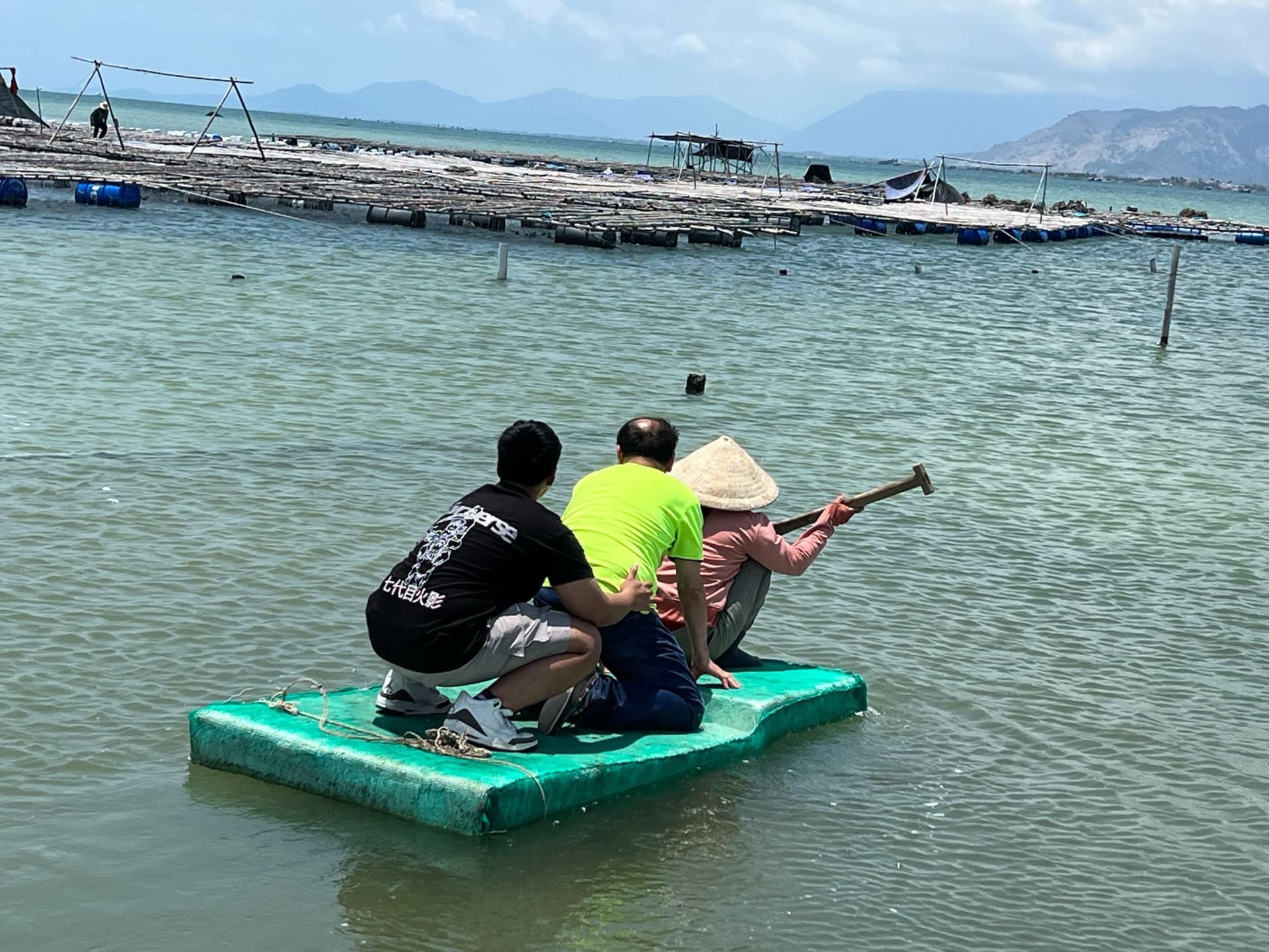 Mr. Nobuyoshi Kan and Takayoshi on a small raft, heading out to an oyster cultivation area in the Nha Trang area